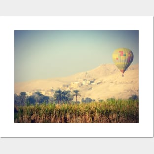 hot air balloon over a traditional village in the Egyptian countryside Posters and Art